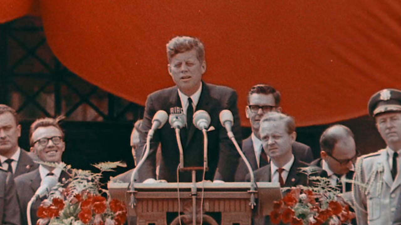 President Kennedy in front of the press giving a speech in Berlin.